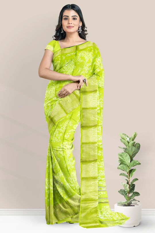 Photo of South Indian bride in a lime green saree with a purple blouse.